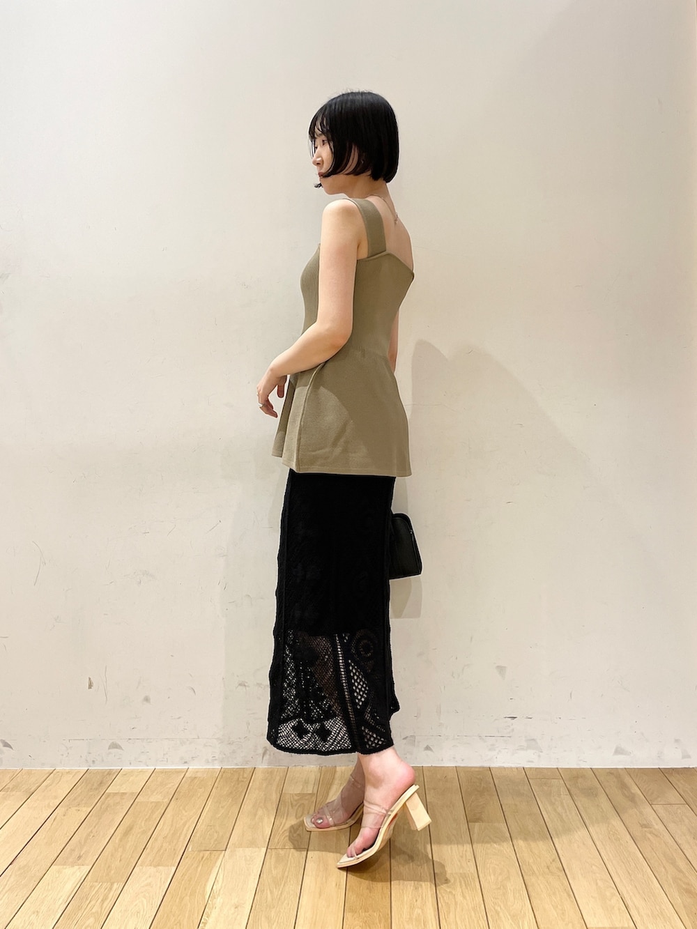 ブラック系のスカート、ブラック系のショルダーバッグ、その他のサンダルを着用したレディースの夏コーディネートの3枚目の写真