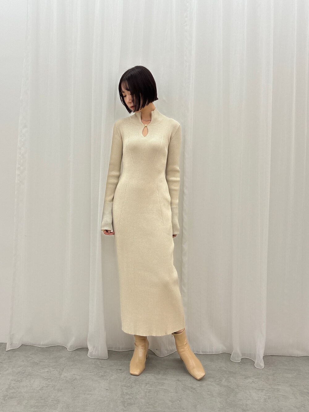 ホワイト系のワンピース、シルバー系のネックレスを着用したレディースの秋コーディネートの3枚目の写真