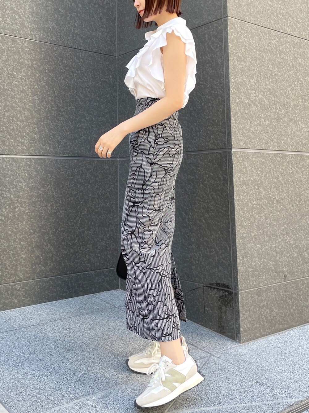 ホワイト系のシャツ/ブラウス、ブラック系のスカート、ブラック系のハンドバッグを着用したレディースの春コーディネートの4枚目の写真