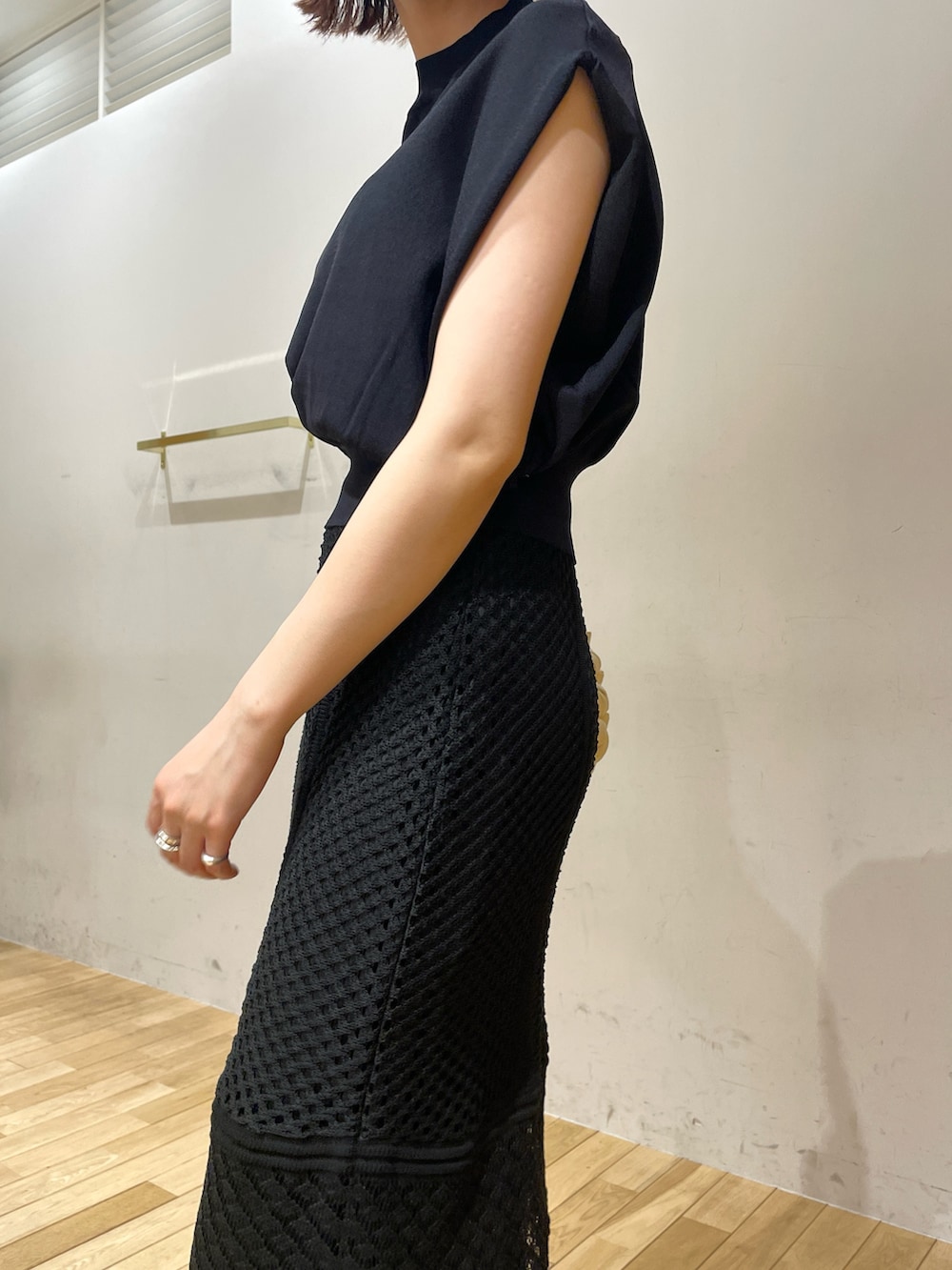 ベージュ系のハンドバッグ、ブラック系のサンダル、ブラック系のニット/セーターを着用したレディースの夏コーディネートの7枚目の写真