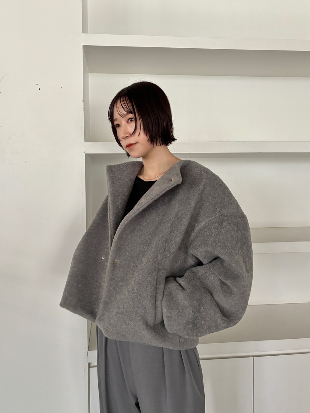 グレー系のブルゾン、グレー系のその他パンツ、ブラック系のブーツを着用したレディースの秋コーディネートの4枚目の写真