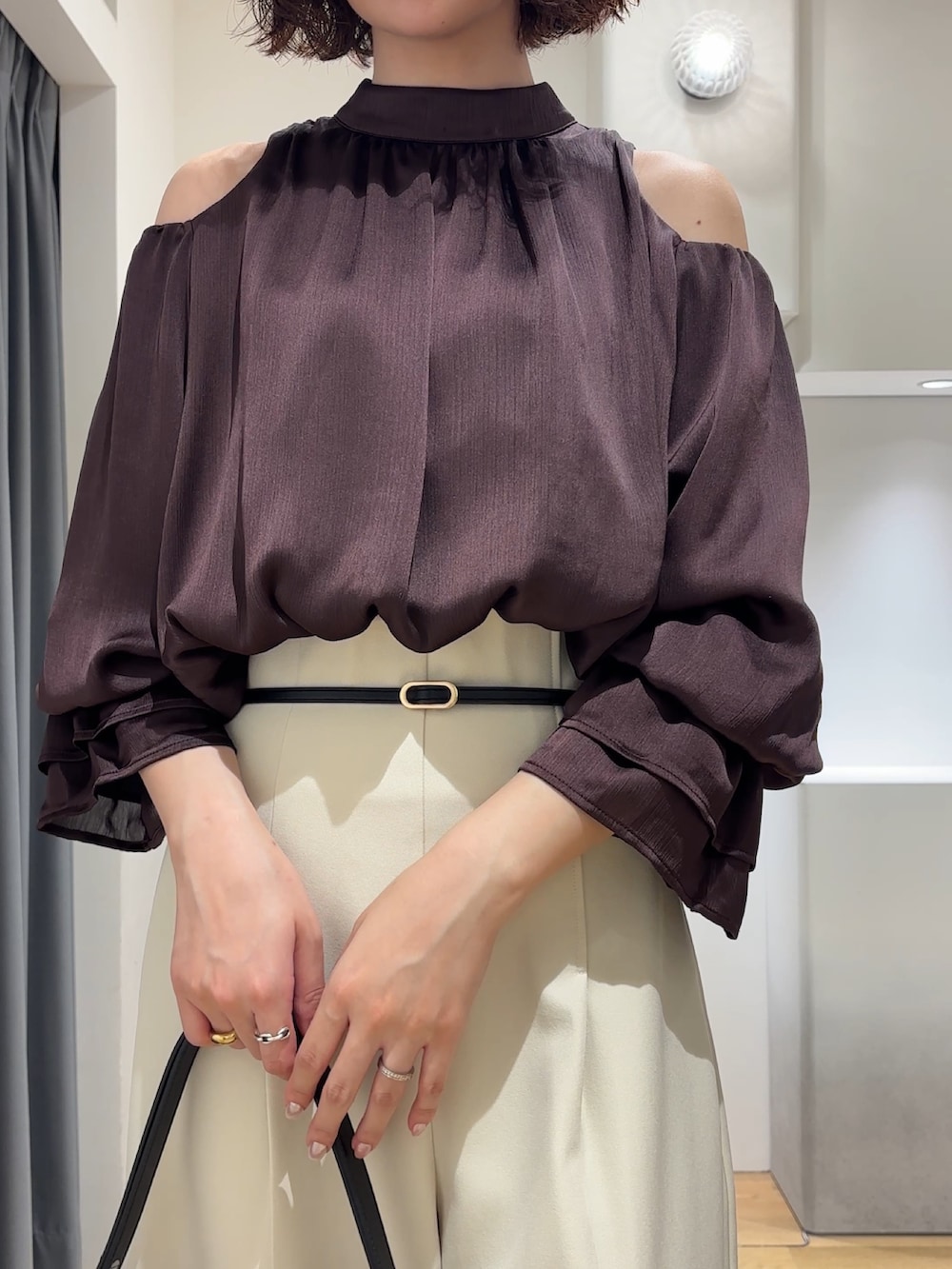 ブラウン系のシャツ/ブラウス、ホワイト系のその他パンツ、ブラック系のハンドバッグを着用したレディースの秋コーディネートの7枚目の写真