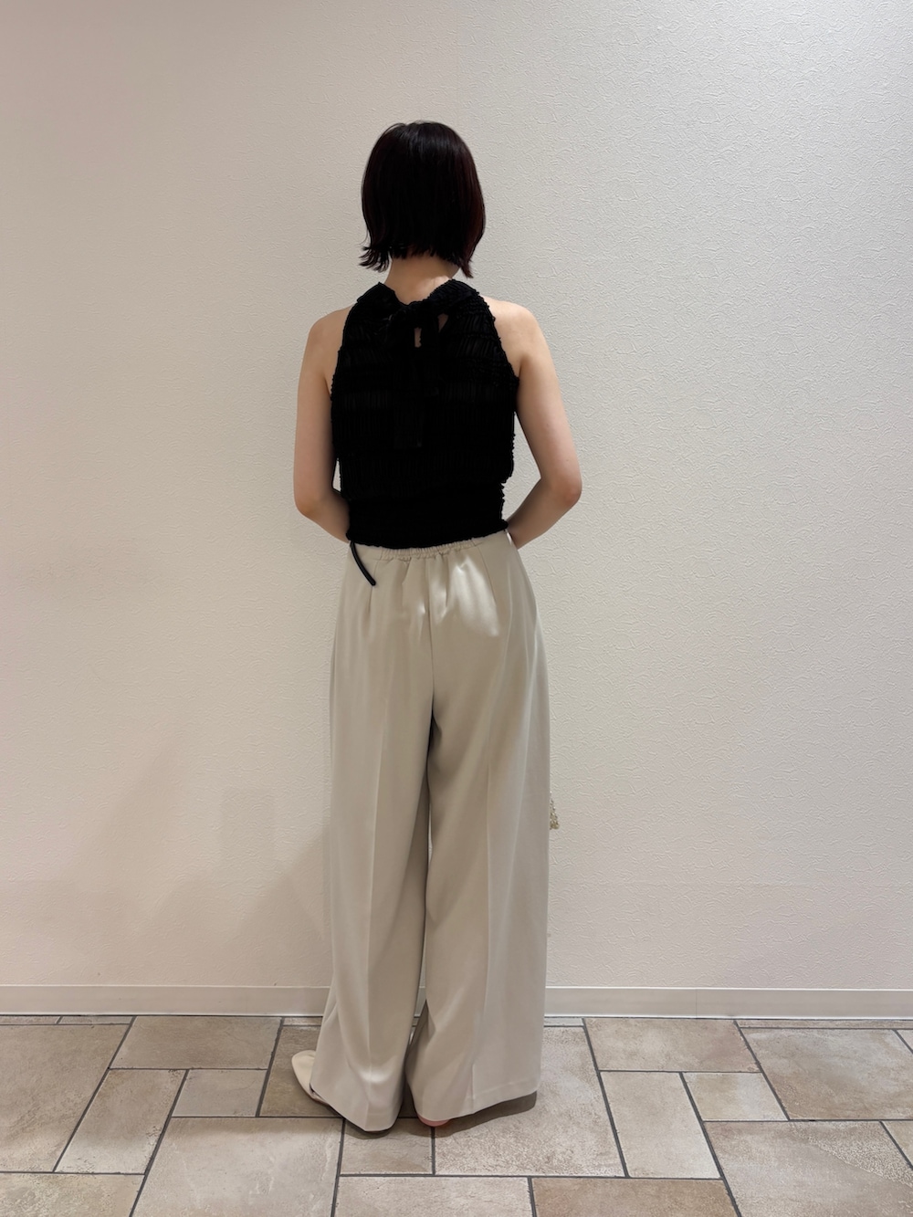 ブラック系のシャツ/ブラウス、ホワイト系のハンドバッグ、ホワイト系のサンダルを着用したレディースの夏コーディネートの4枚目の写真