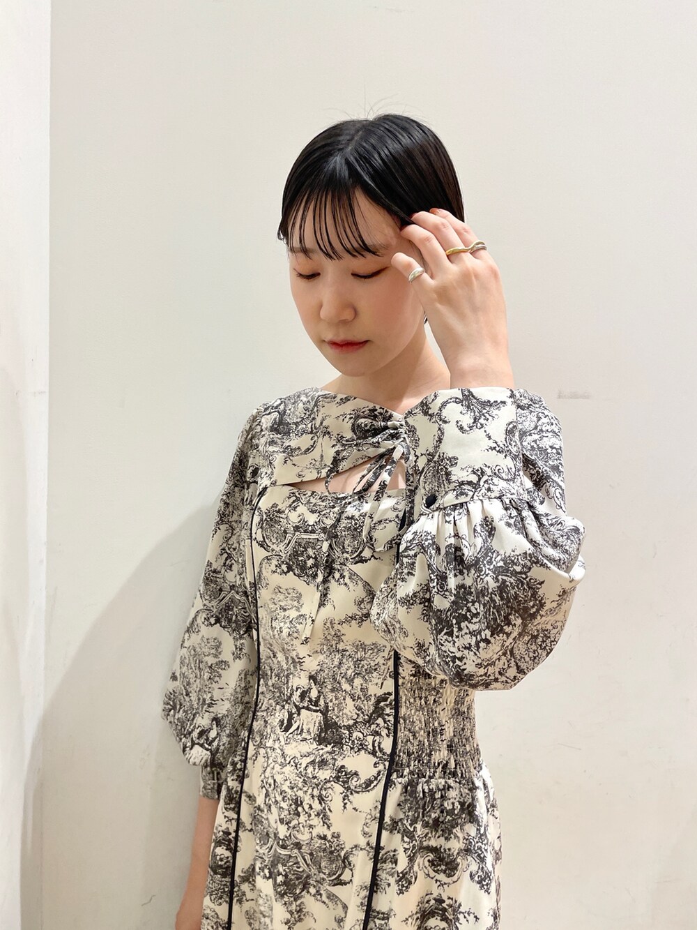 ホワイト系のワンピース、ブラック系のブーツ、ホワイト系のハンドバッグを着用したレディースの冬コーディネートの7枚目の写真