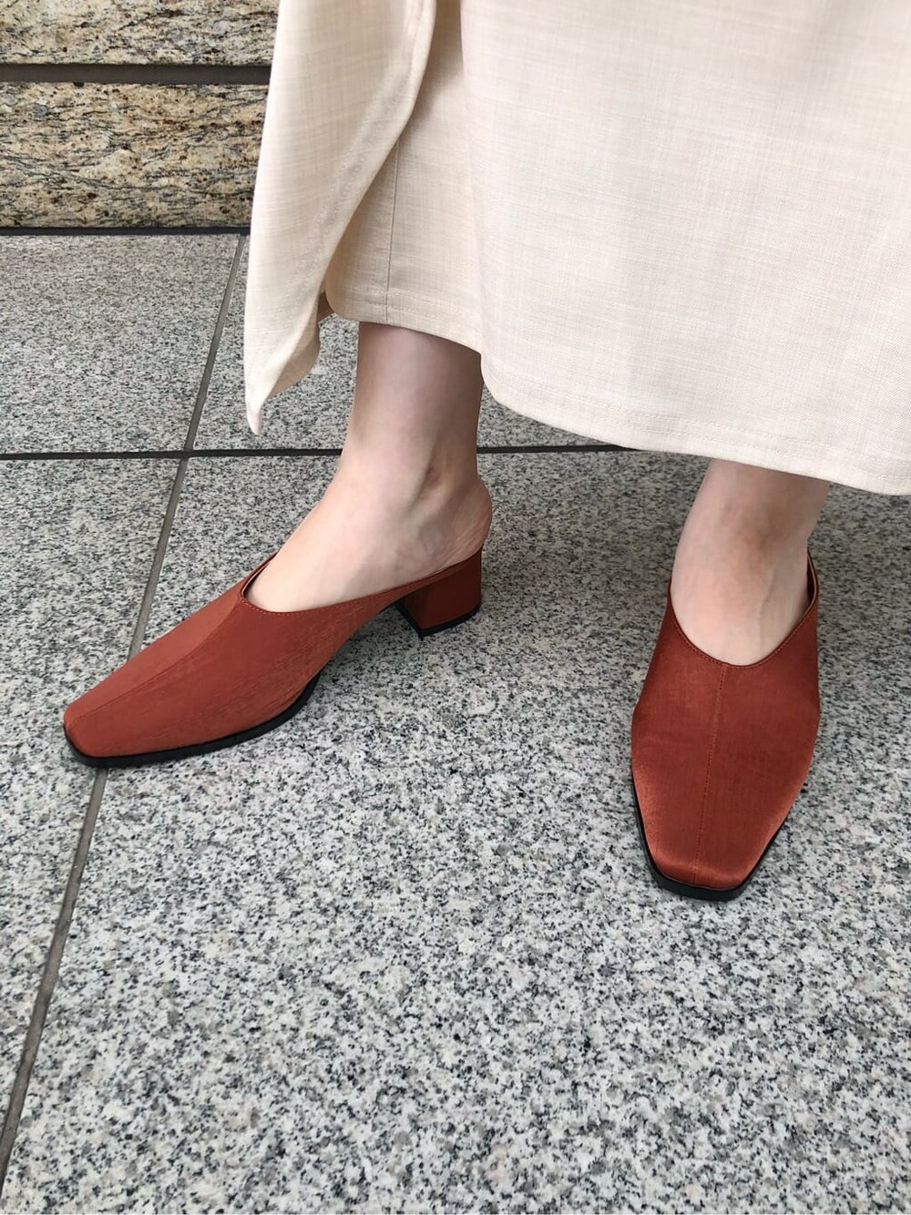 ホワイト系のシャツ/ブラウス、ホワイト系のスカート、オレンジ系のスリッポンを着用したレディースの夏コーディネートの7枚目の写真