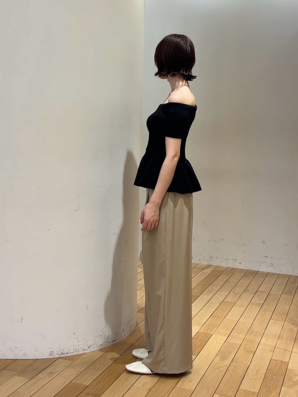 ベージュ系のその他パンツ、ホワイト系のサンダル、ブラウン系のハンドバッグを着用したレディースの夏コーディネートの3枚目の写真