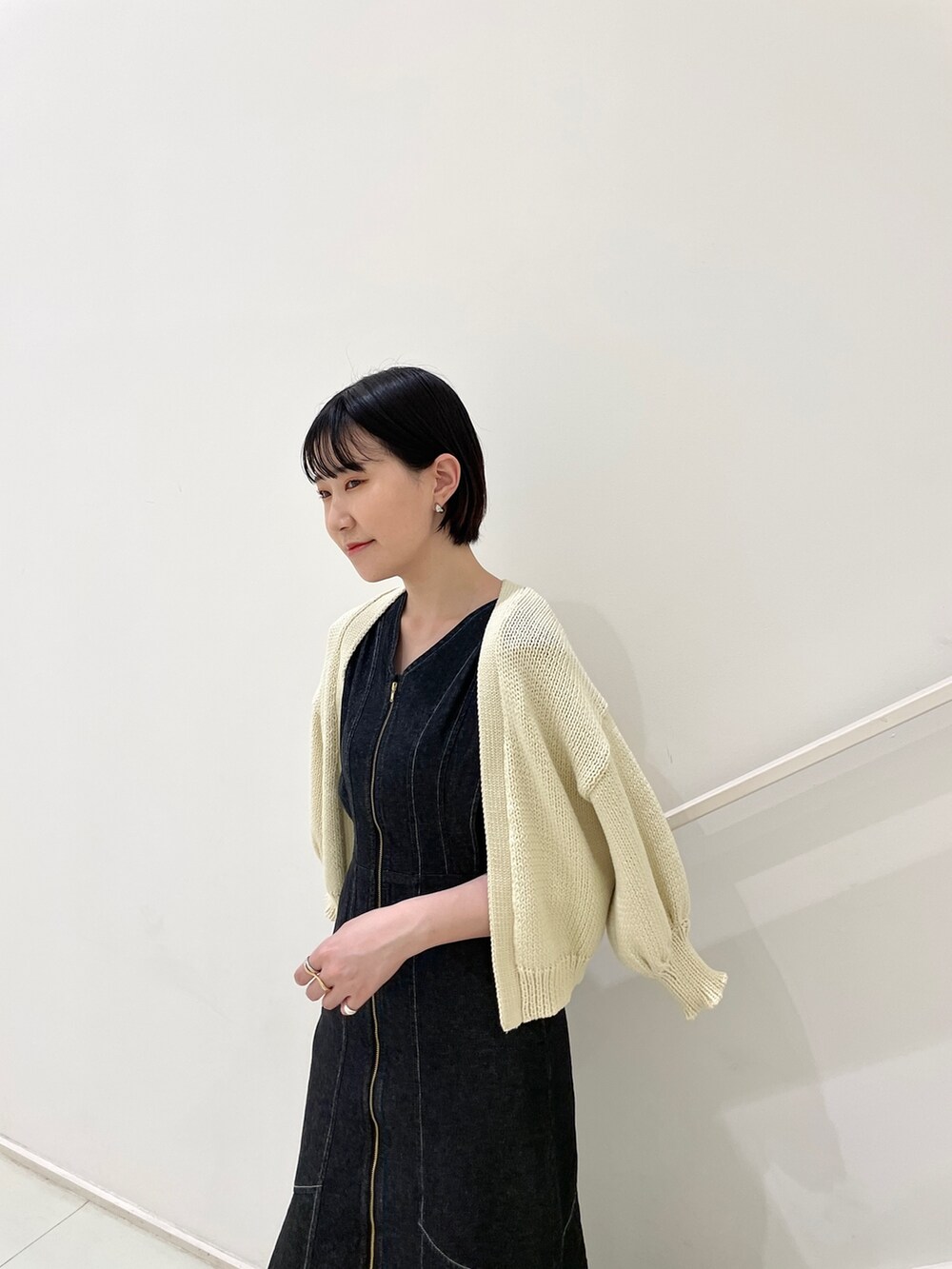 ブラック系のワンピース、ベージュ系のカーディガン/ボレロ、その他のサンダルを着用したレディースの春コーディネートの8枚目の写真