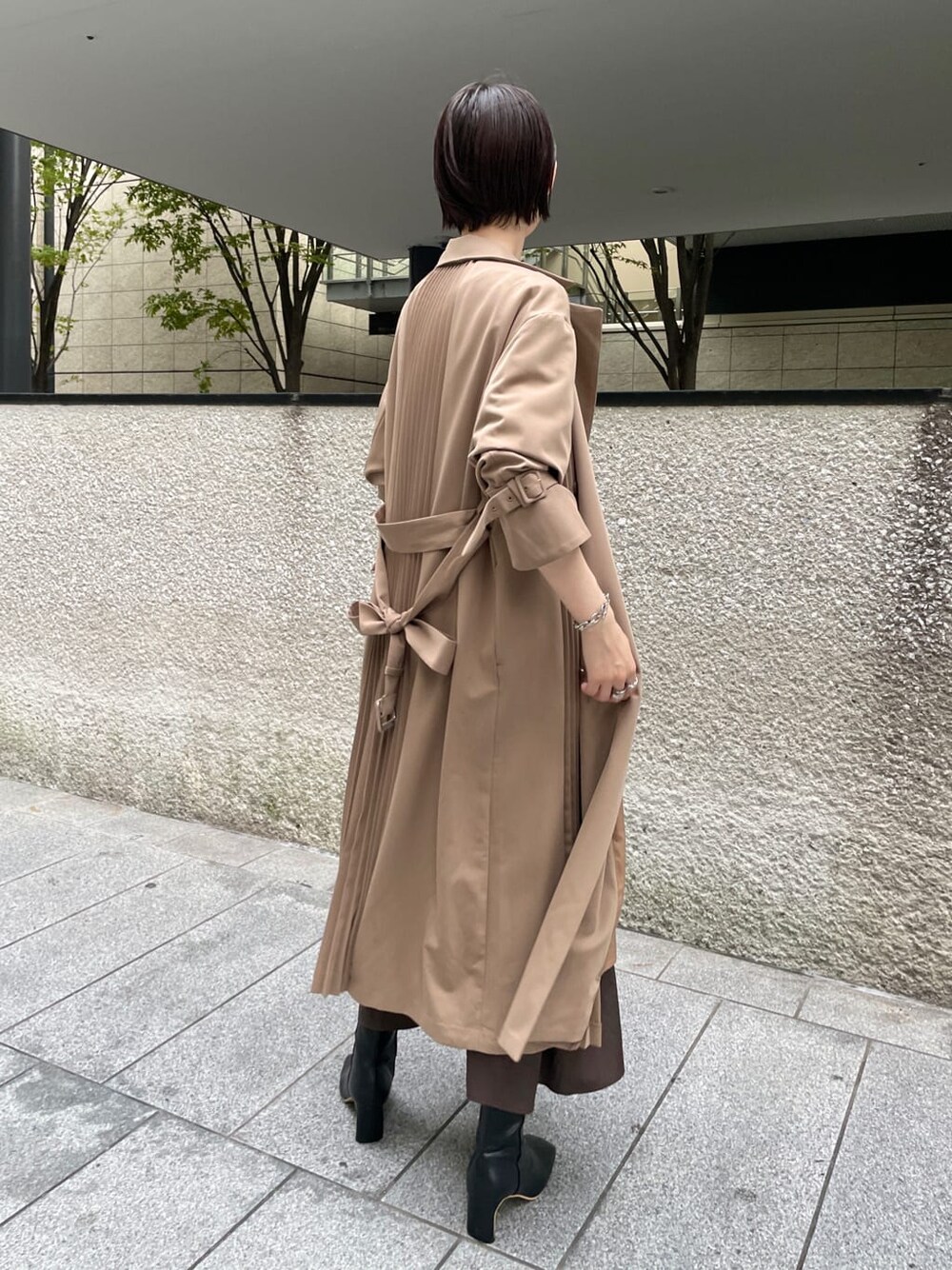 ブラック系のその他シューズ、ベージュ系のその他アウター、ブラウン系のスカートを着用したレディースの秋コーディネートの10枚目の写真