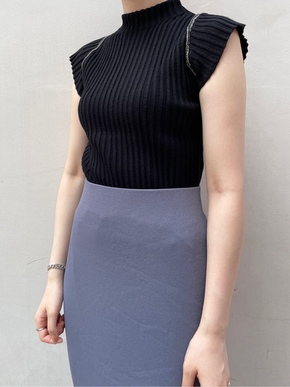 ホワイト系のサンダル、ブルー系のスカート、ブラック系のニット/セーターを着用したレディースの夏コーディネートの7枚目の写真