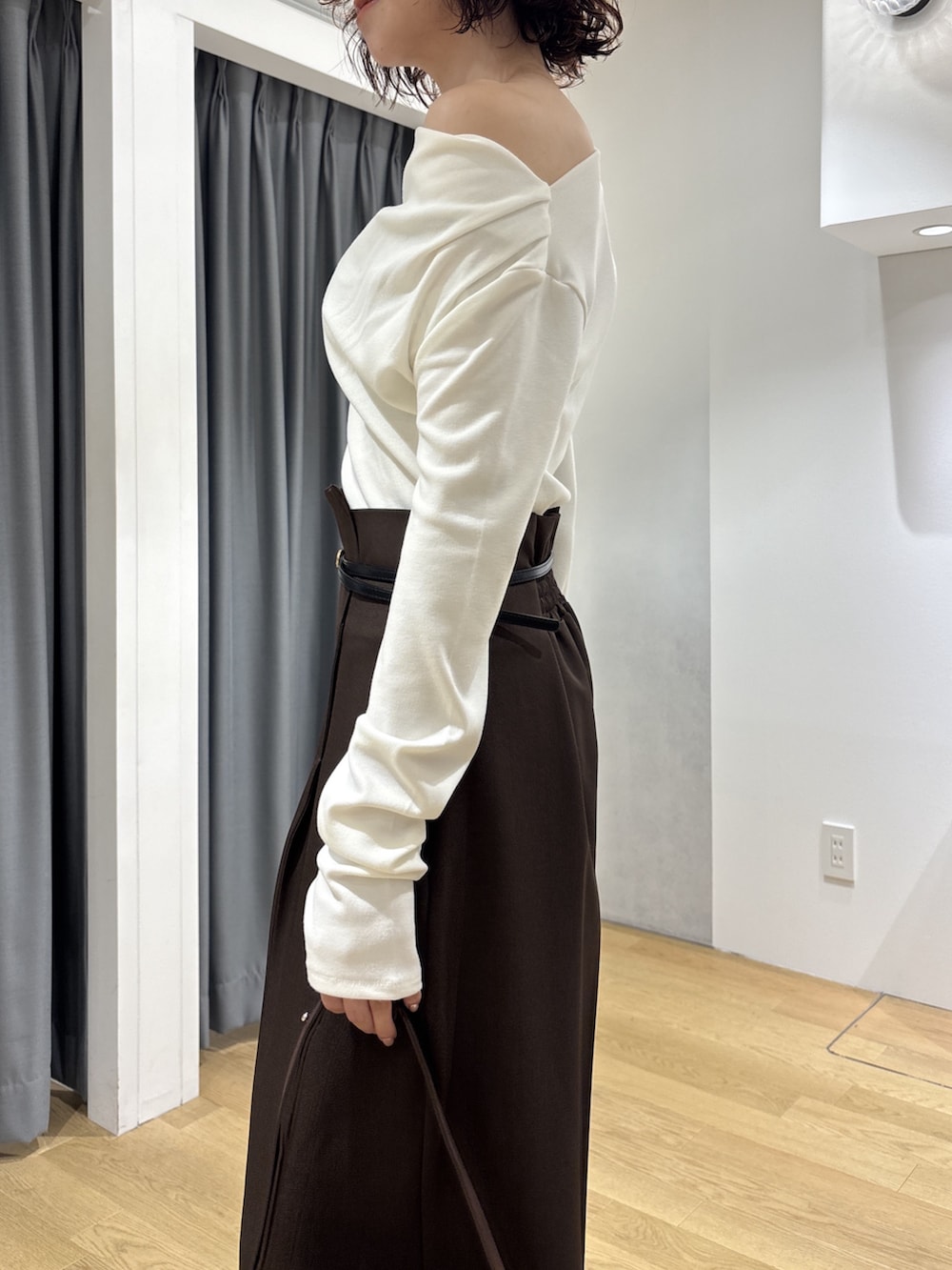 ブラウン系のその他パンツ、ホワイト系のニット/セーター、ブラウン系のハンドバッグを着用したレディースの秋コーディネートの7枚目の写真
