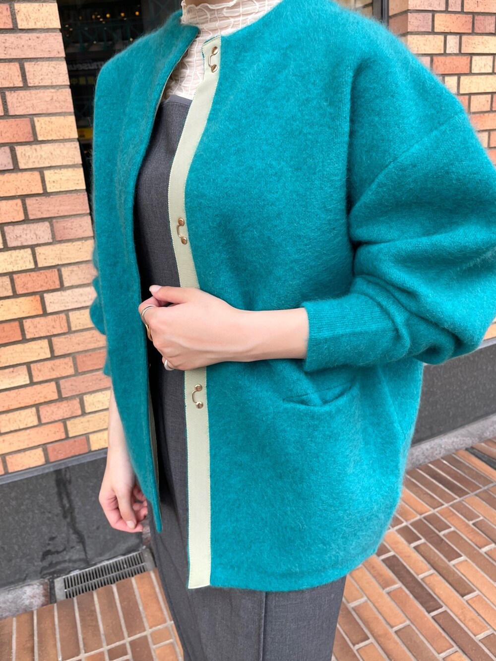 ブルー系のカーディガン/ボレロ、グレー系のワンピース、ホワイト系のTシャツ/カットソーを着用したレディースの秋コーディネートの6枚目の写真