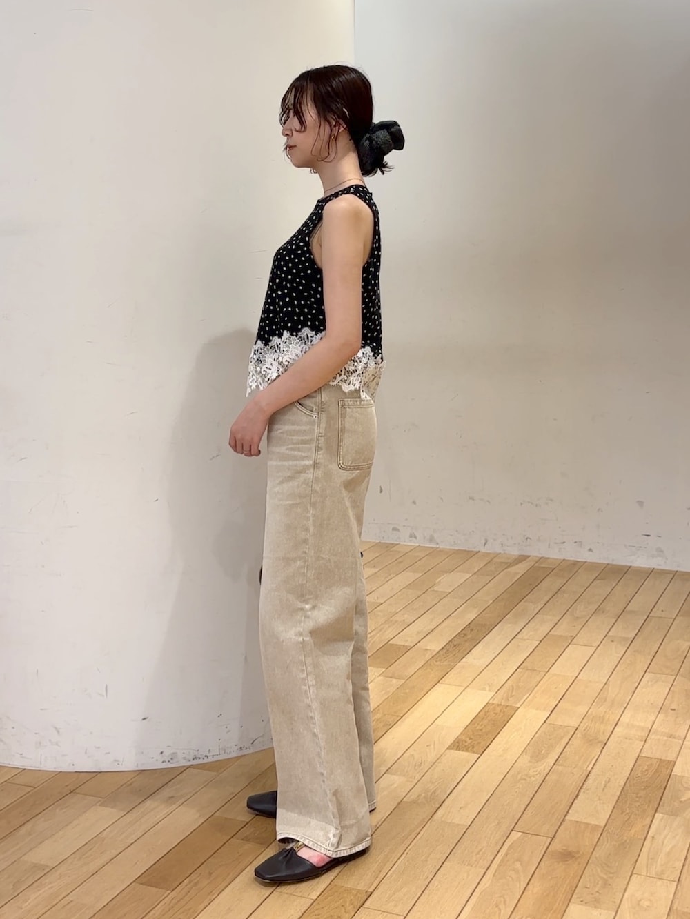 ベージュ系のデニムパンツ、ブラック系のシャツ/ブラウス、ブラック系のハンドバッグを着用したレディースの夏コーディネートの2枚目の写真