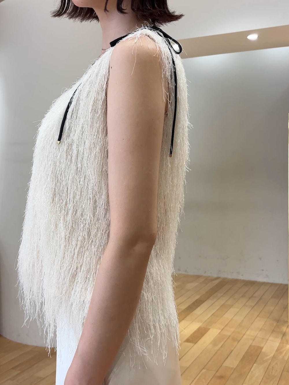 ホワイト系のスカート、ホワイト系のTシャツ/カットソー、ホワイト系のサンダルを着用したレディースの夏コーディネートの6枚目の写真