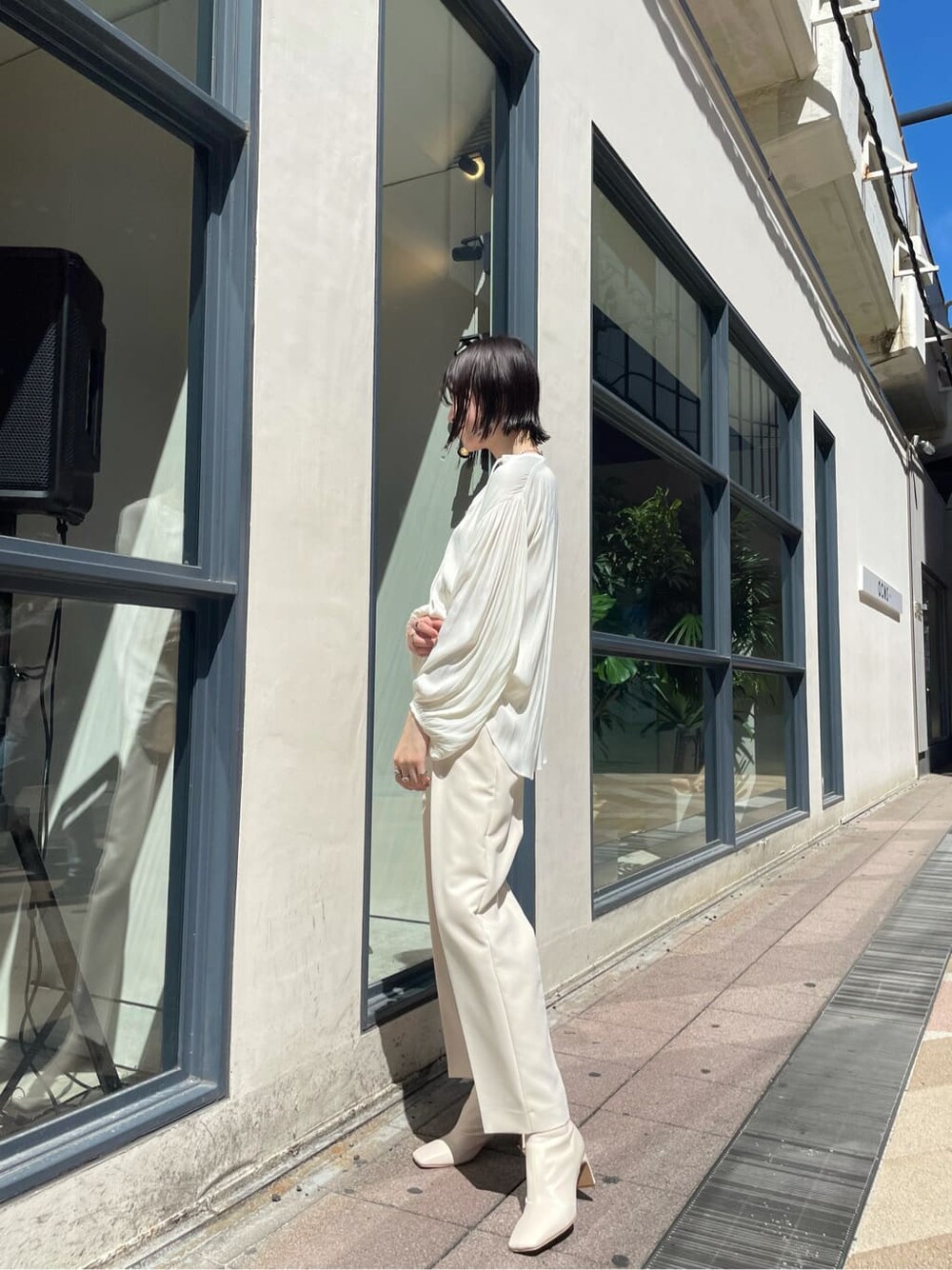 ホワイト系のシャツ/ブラウス、ホワイト系のその他シューズ、ベージュ系のその他アウターを着用したレディースの秋コーディネートの2枚目の写真