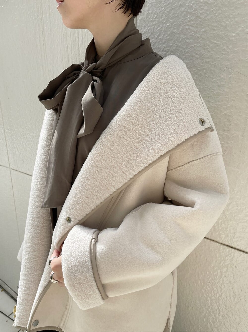 ブラック系のその他シューズ、ホワイト系のその他アウター、ブラウン系のシャツ/ブラウスを着用したレディースの冬コーディネートの9枚目の写真