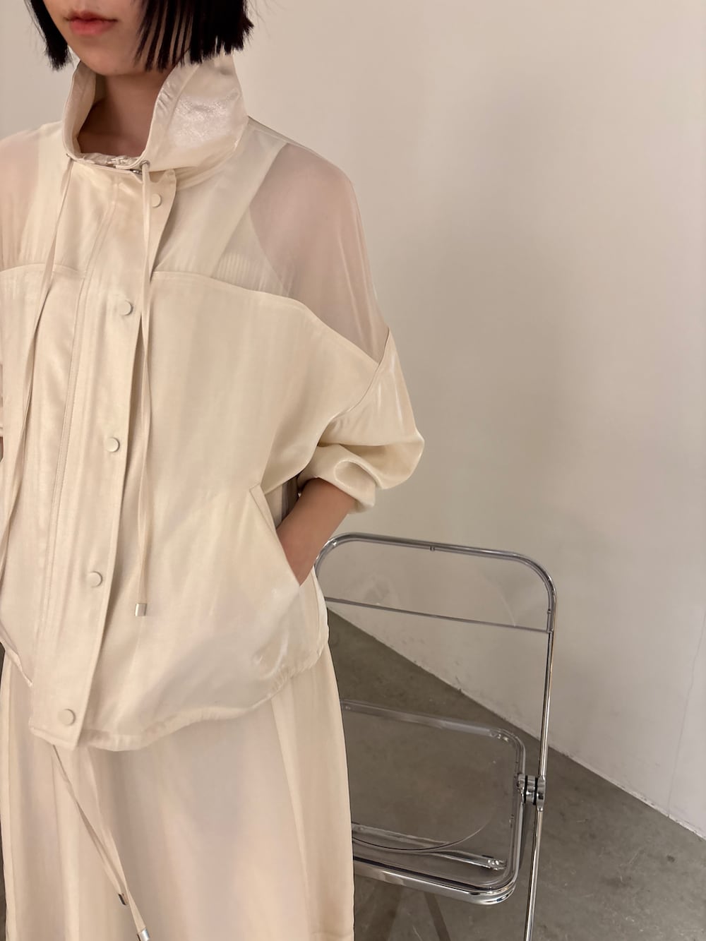 ホワイト系のスカート、ホワイト系のブルゾン、ホワイト系のタンクトップを着用したレディースの春コーディネートの3枚目の写真