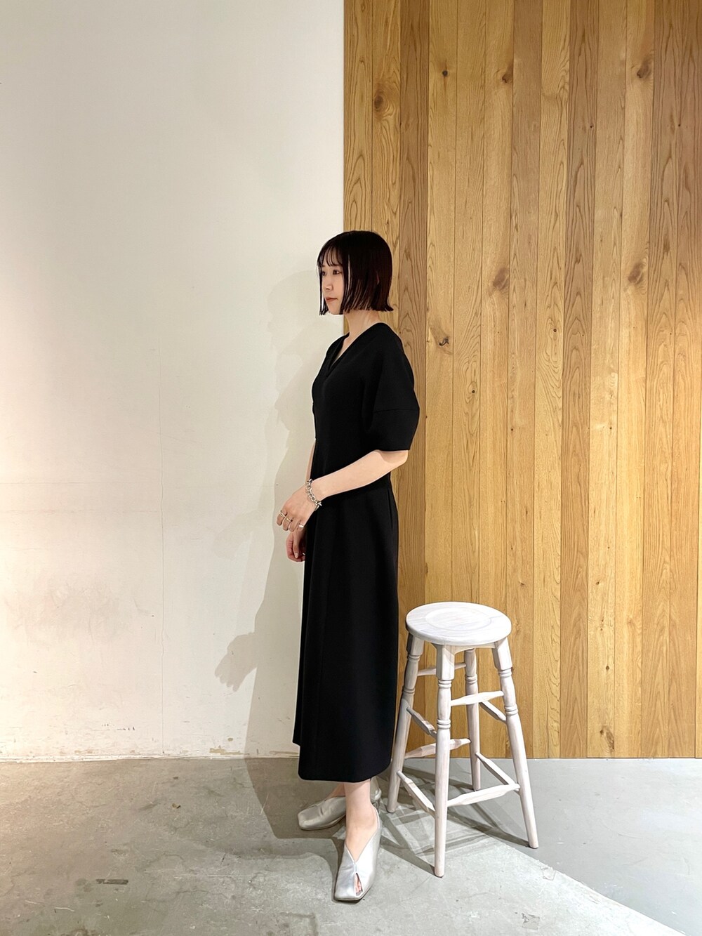 シルバー系のパンプス、ブラック系のワンピースを着用したレディースの春コーディネートの3枚目の写真