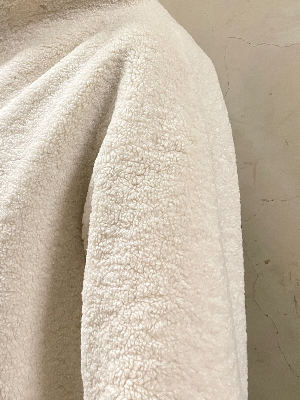 ホワイト系のブルゾン、ブラック系のブーツ、ブラウン系のワンピースを着用したレディースの秋コーディネートの6枚目の写真