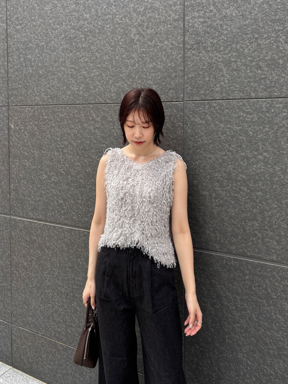 ブラウン系のパンプス、ブラック系のデニムパンツ、ブラウン系のボストンバッグを着用したレディースの夏コーディネートの5枚目の写真