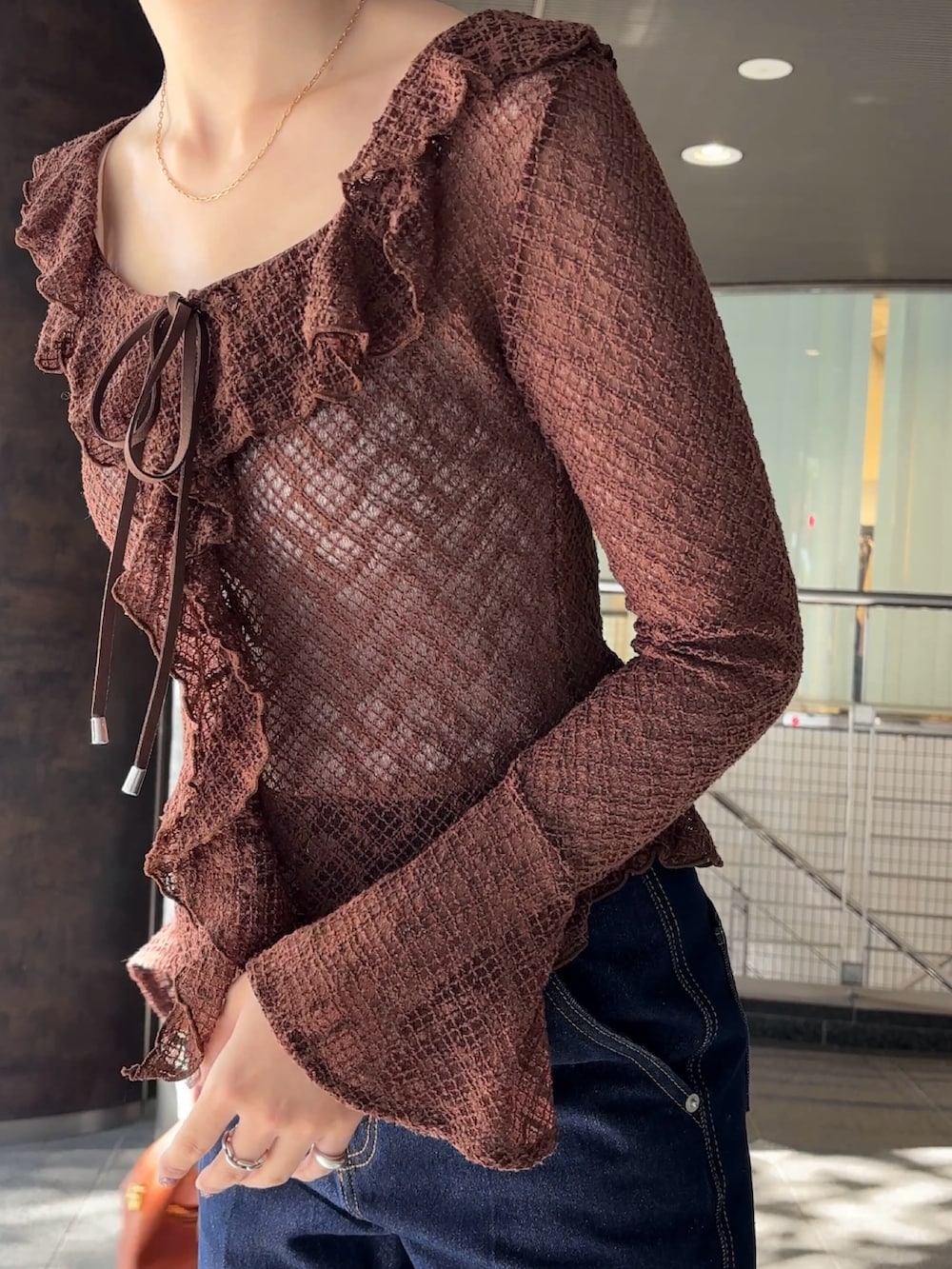 ブラウン系のシャツ/ブラウス、シルバー系のパンプス、ブラウン系のハンドバッグを着用したレディースの冬コーディネートの5枚目の写真