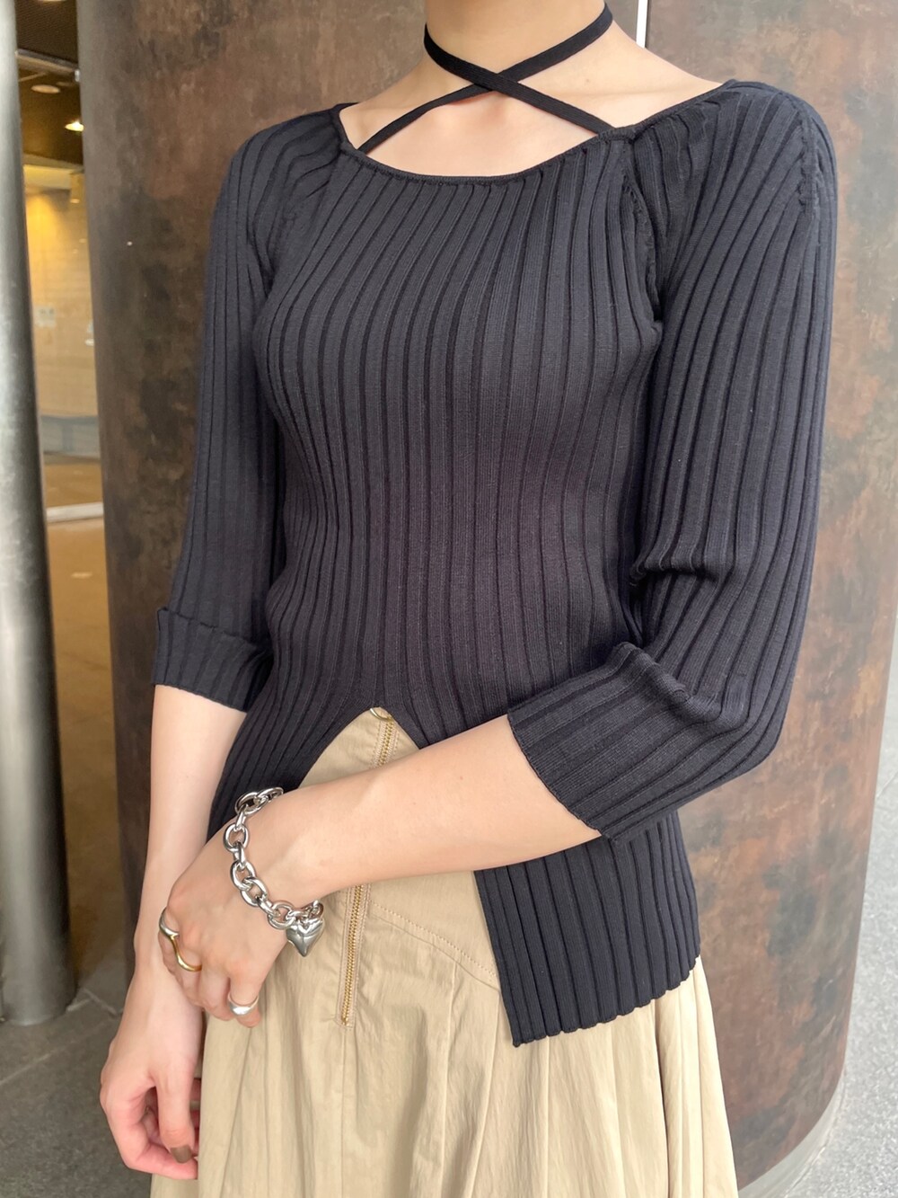 ブラック系のスニーカー、ブラック系のニット/セーター、ベージュ系のスカートを着用したレディースの春コーディネートの5枚目の写真