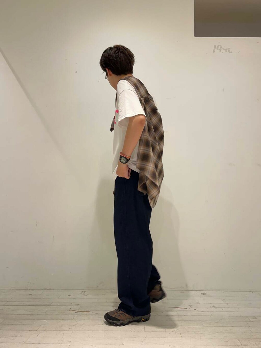 ブルー系のデニムパンツ、ブラウン系のスニーカー、ホワイト系のTシャツ/カットソーを着用したメンズの秋コーディネートの2枚目の写真