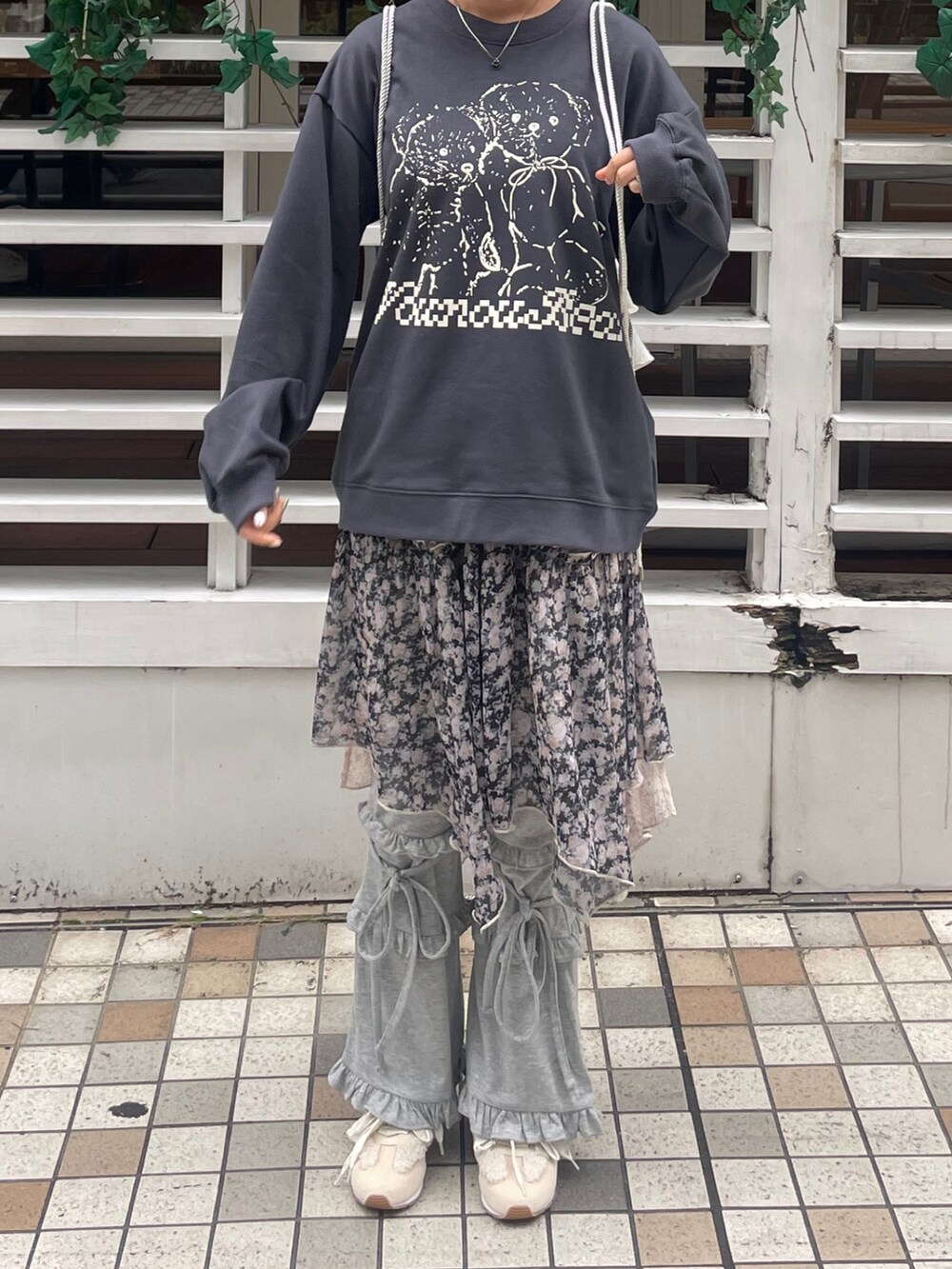 ブラック系のスカート、グレー系のスウェットパンツ、ホワイト系のスニーカーを着用したレディースの秋コーディネートの3枚目の写真