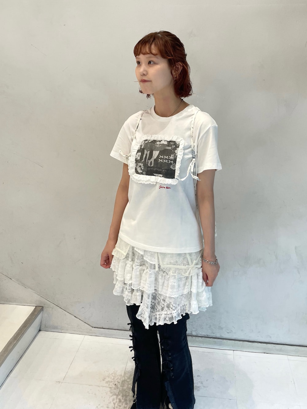 ホワイト系のスカート、ブラック系のデニムパンツ、ホワイト系のTシャツ/カットソーを着用したレディースの夏コーディネートの6枚目の写真