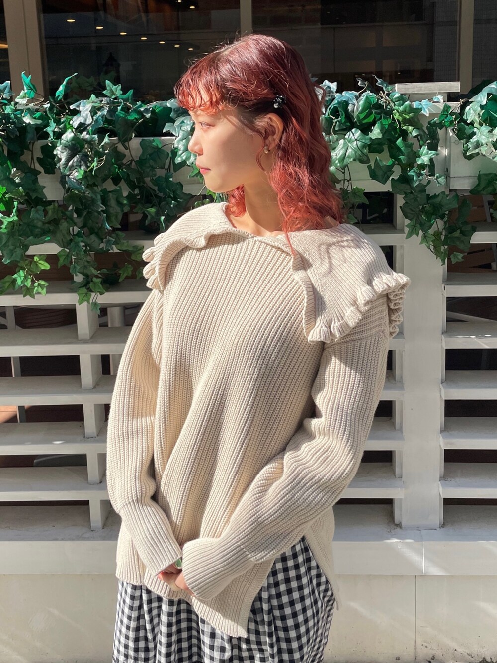 ホワイト系のニット/セーター、ブラック系のスカート、ブラック系のモカシン/デッキシューズを着用したレディースの冬コーディネートの3枚目の写真