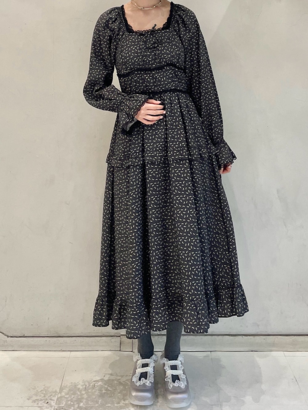 グレー系のパーカー、グレー系のメッセンジャーバッグ、ブラック系のワンピースを着用したレディースの冬コーディネートの7枚目の写真