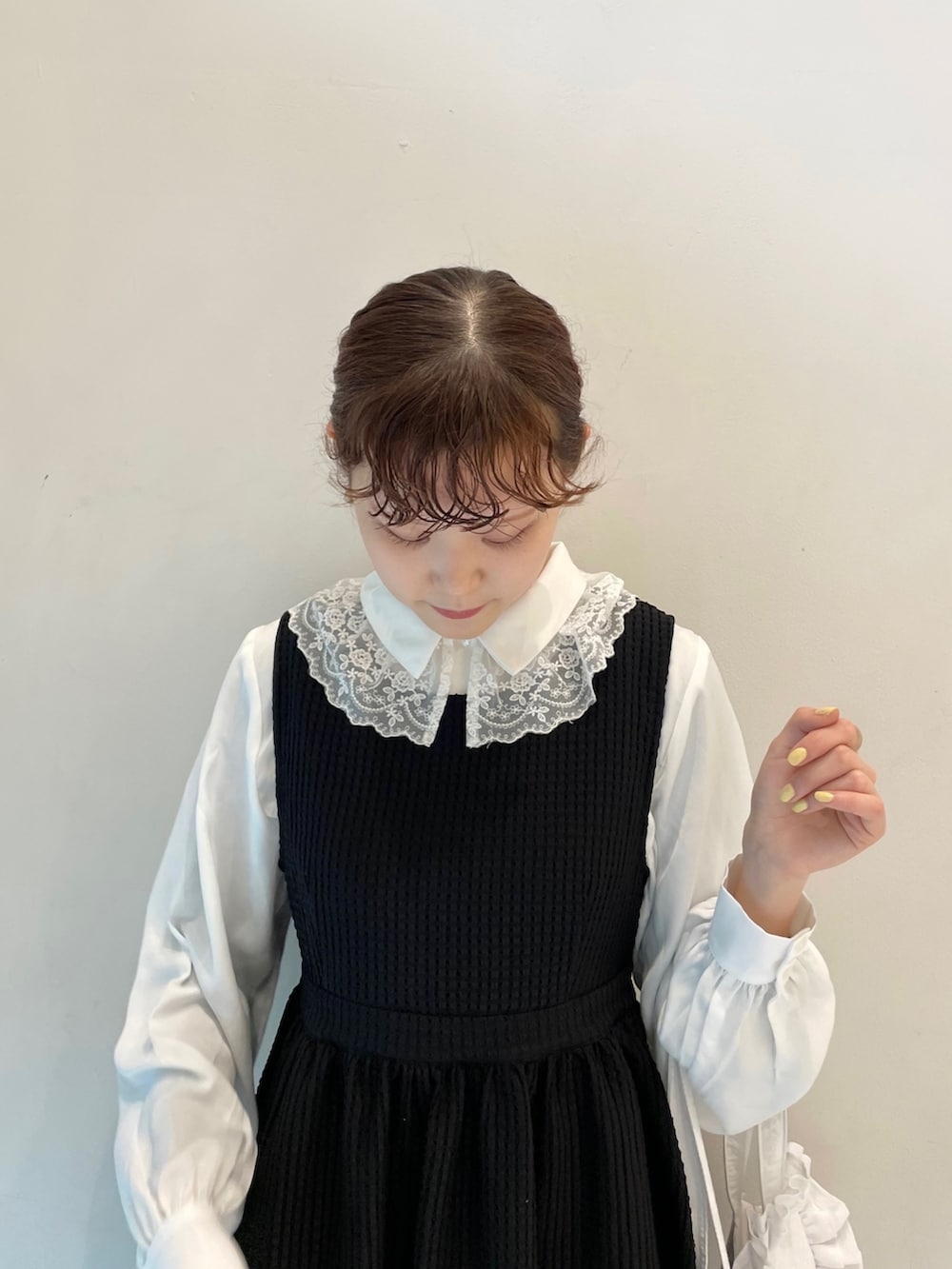 ブラック系のワンピース、ホワイト系のトートバッグ、ブラック系のスニーカーを着用したレディースの春コーディネートの5枚目の写真