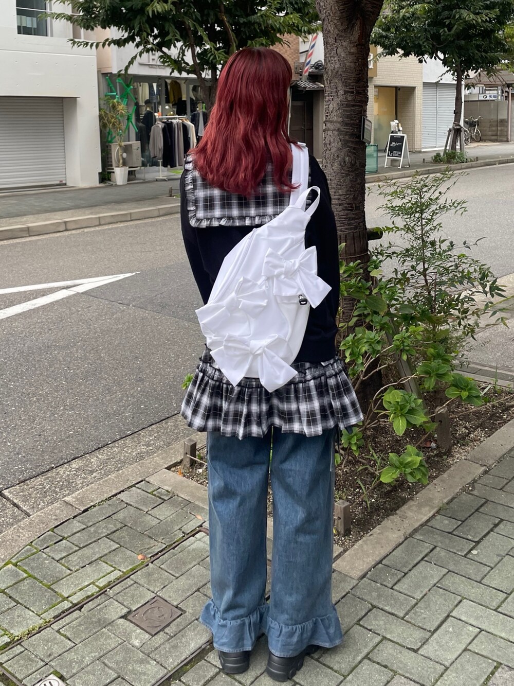 ホワイト系のショルダーバッグ、ブラック系のワンピース、ブラック系のスウェットを着用したレディースの秋コーディネートの4枚目の写真