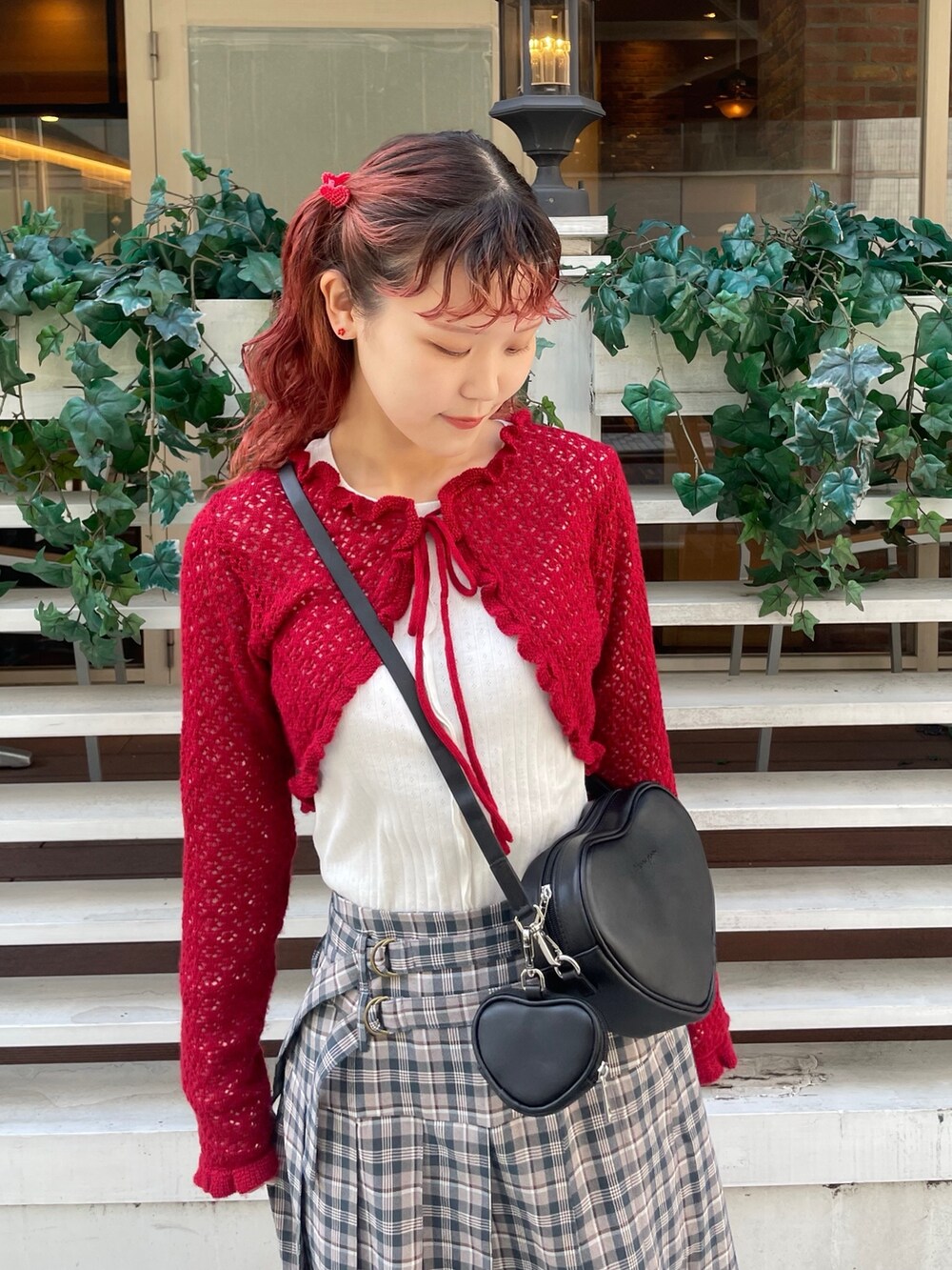 ブラック系のスニーカー、ホワイト系のTシャツ/カットソー、レッド系のカーディガン/ボレロを着用したレディースの春コーディネートの5枚目の写真