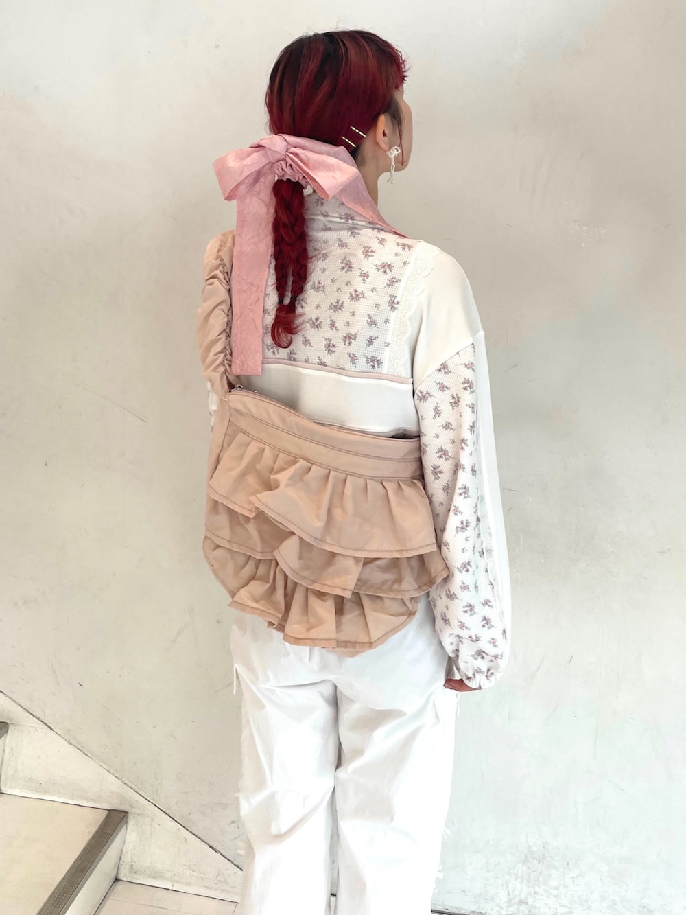 ピンク系のスニーカー、ピンク系のショルダーバッグ、ピンク系のジャージを着用したレディースの冬コーディネートの5枚目の写真