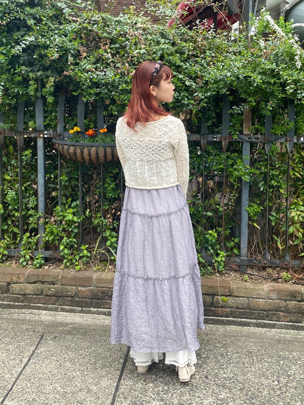 ホワイト系のニット/セーター、グレー系のワンピース、ホワイト系のスラックスを着用したレディースの春コーディネートの4枚目の写真