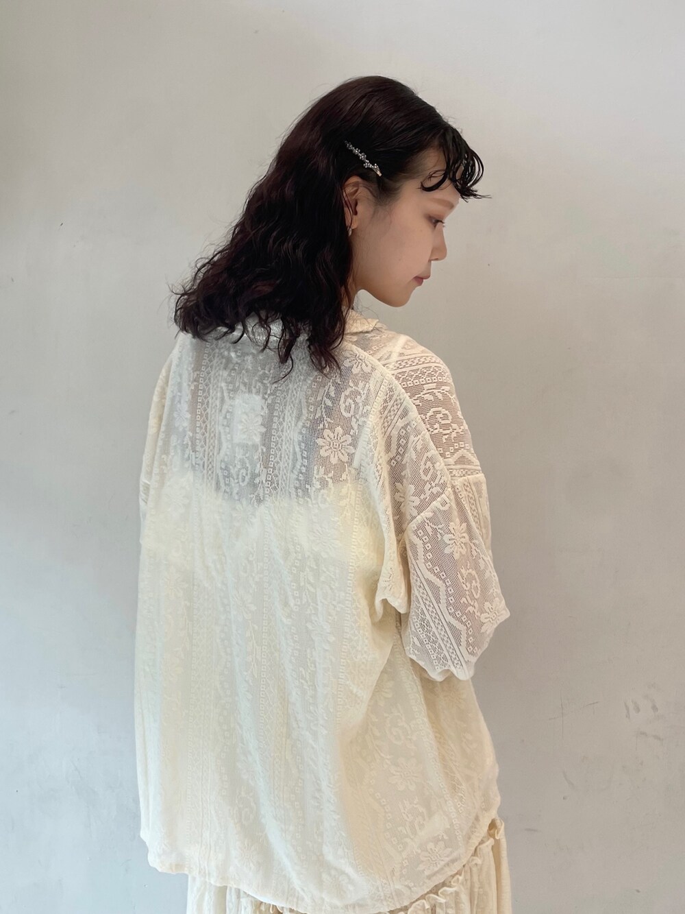 ホワイト系のスカート、ホワイト系のパンプス、ホワイト系のキャミソールを着用したレディースの夏コーディネートの5枚目の写真