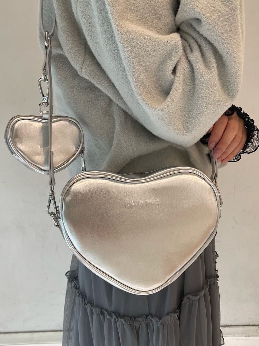 グレー系のワンピース、シルバー系のショルダーバッグ、グレー系のカーディガン/ボレロを着用したレディースの夏コーディネートの8枚目の写真