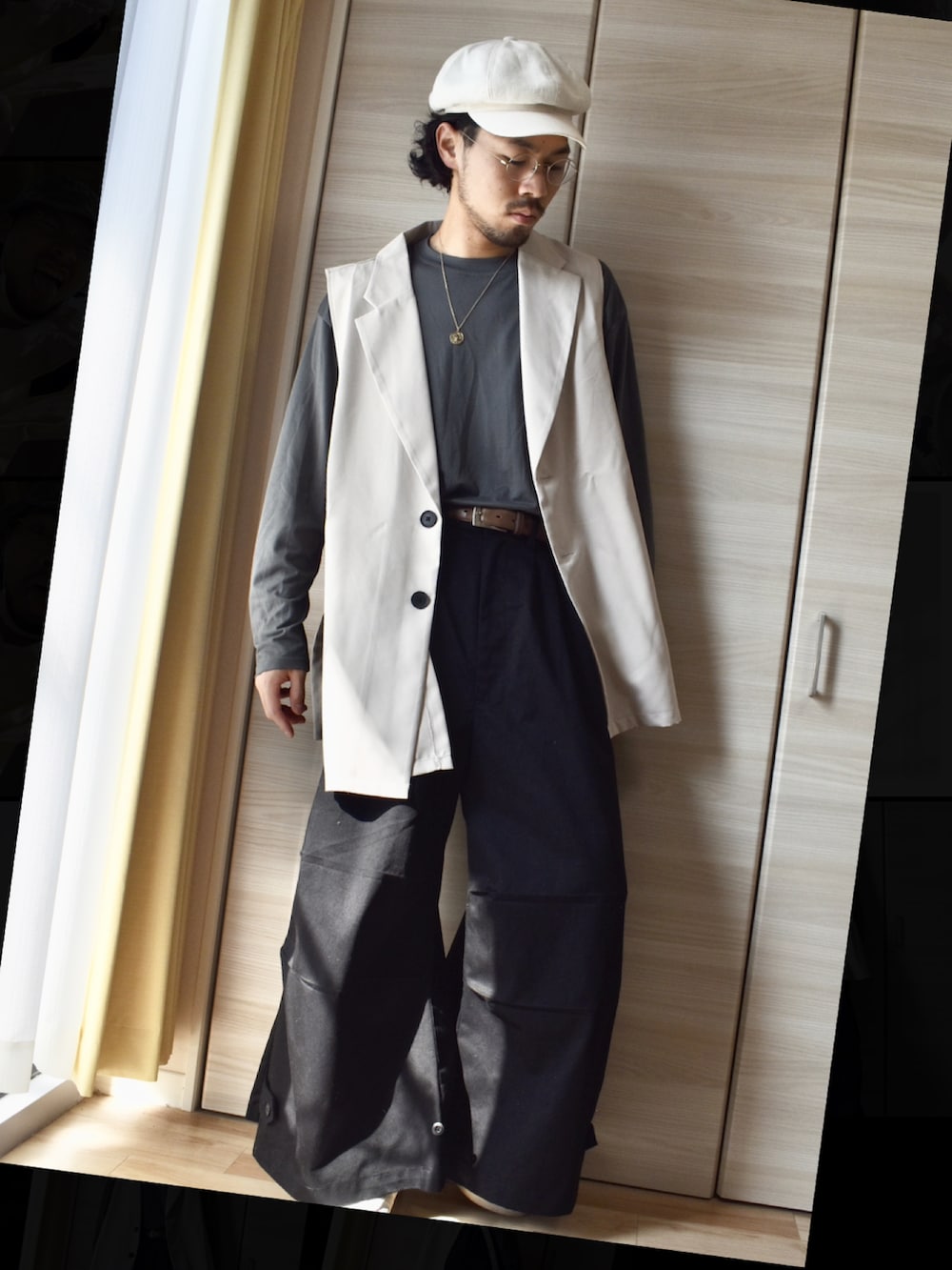 グレー系のTシャツ/カットソー、ベージュ系のベスト、ブラック系のその他パンツを着用したメンズの春コーディネートの3枚目の写真