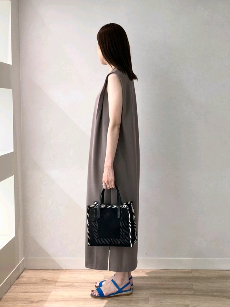 グリーン系のワンピース、ブラック系のトートバッグ、ブルー系のサンダルを着用したレディースの夏コーディネートの4枚目の写真