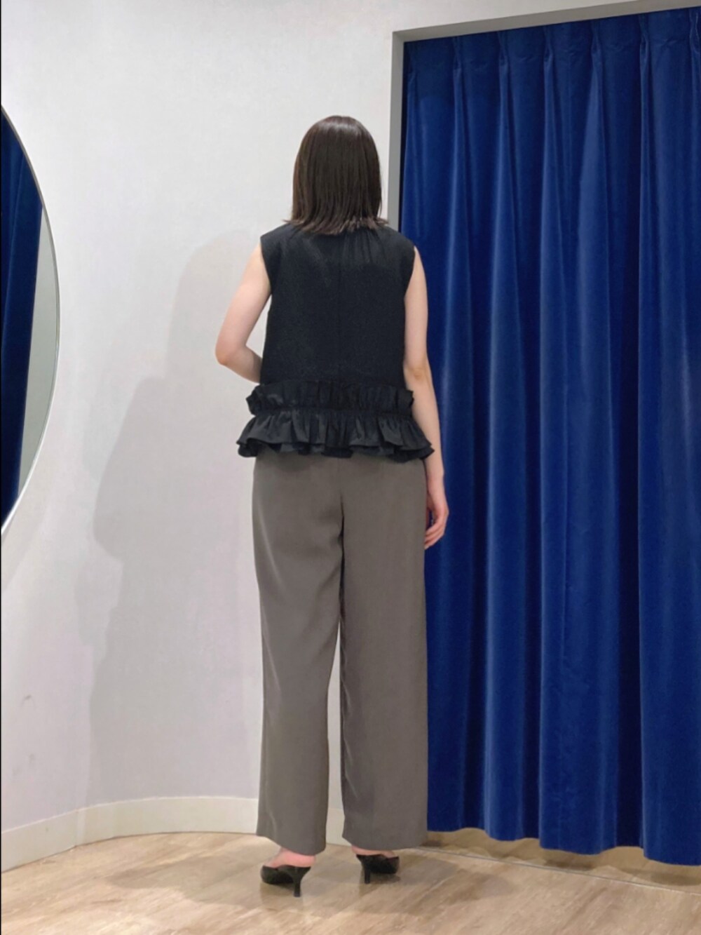 ブラック系のベスト、ブラウン系のその他パンツ、シルバー系のネックレスを着用したレディースの秋コーディネートの6枚目の写真