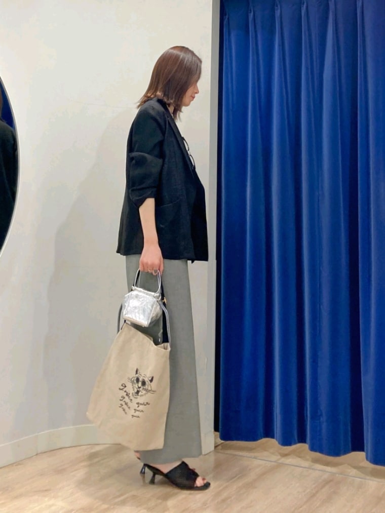 ブラック系のテーラードジャケット、グリーン系のキャミソール、グレー系のつなぎ/オールインワンを着用したレディースの春コーディネートの5枚目の写真