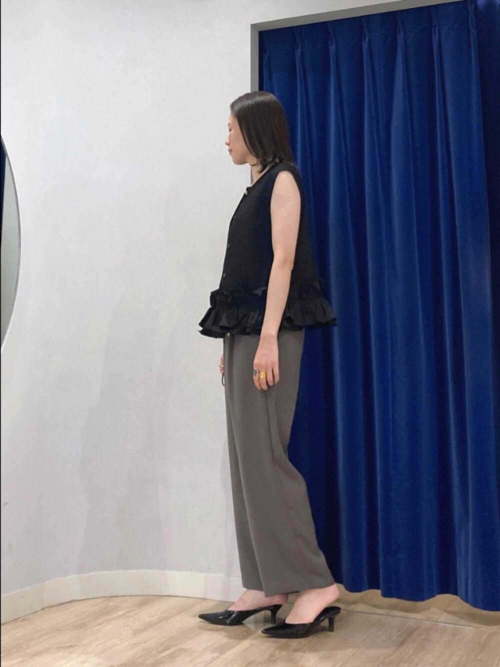 ブラック系のベスト、ブラウン系のその他パンツ、シルバー系のネックレスを着用したレディースの秋コーディネートの4枚目の写真