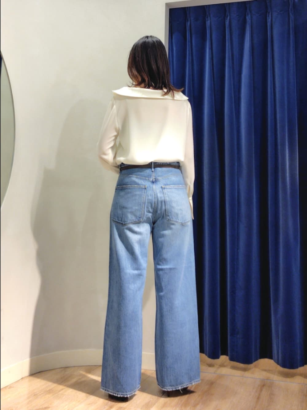 ブルー系のシャツ/ブラウス、イエロー系のブルゾン、ブルー系のデニムパンツを着用したレディースの秋コーディネートの4枚目の写真