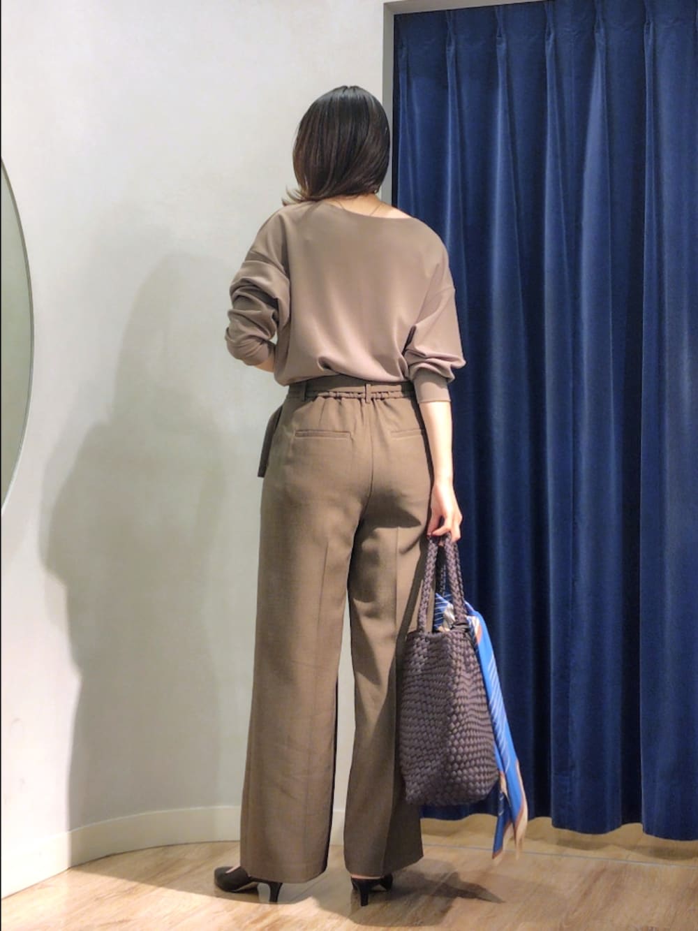 グリーン系のTシャツ/カットソー、ブラウン系のその他パンツ、グレー系のトートバッグを着用したレディースの秋コーディネートの6枚目の写真