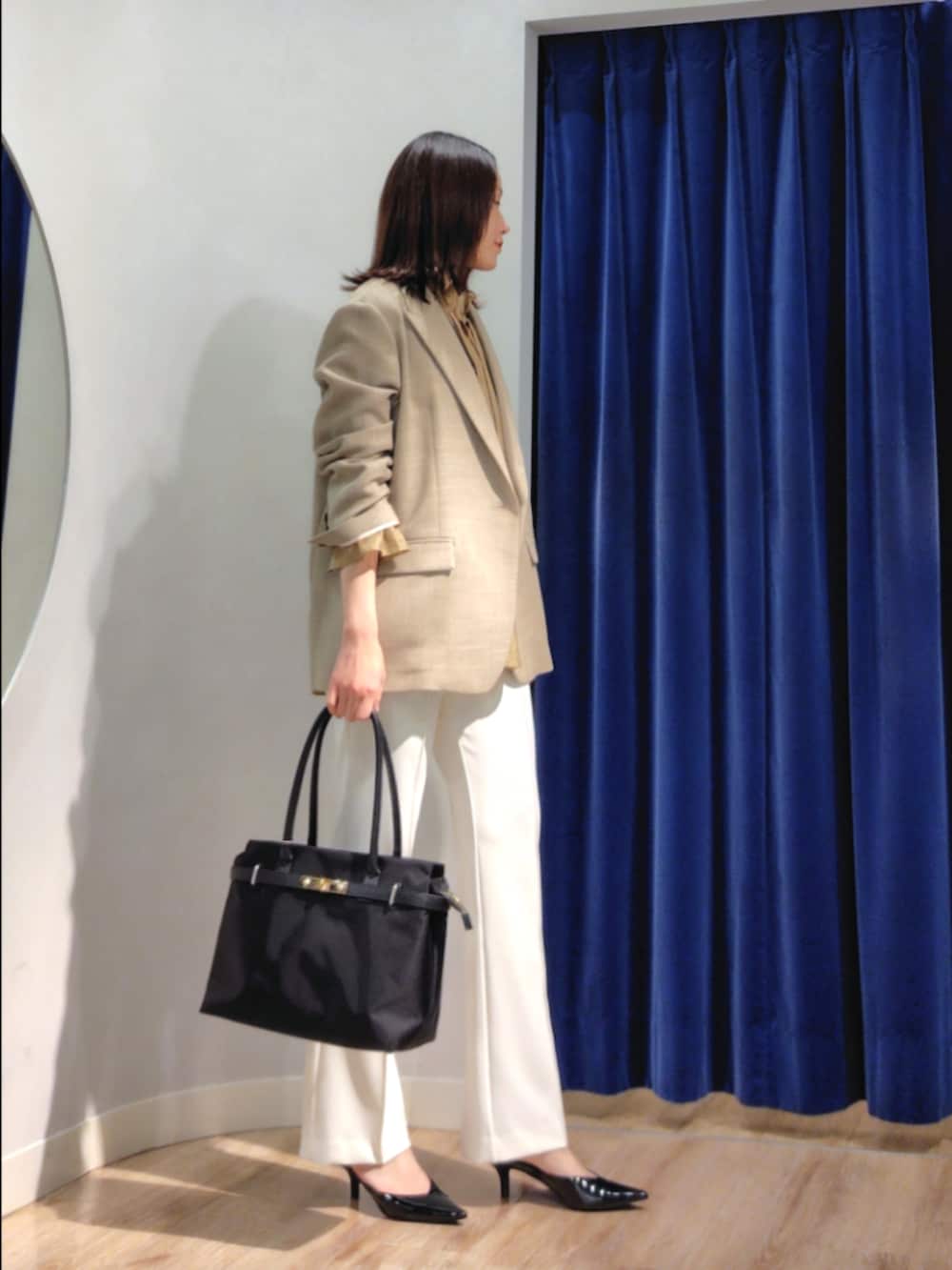 ベージュ系のテーラードジャケット、イエロー系のシャツ/ブラウス、ホワイト系のその他パンツを着用したレディースの春コーディネートの3枚目の写真