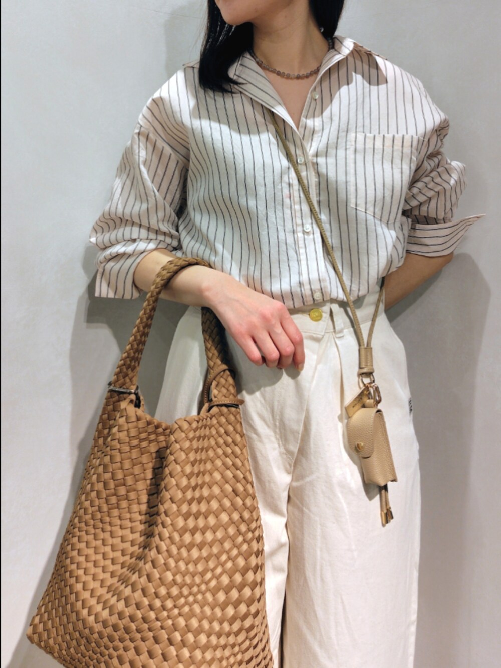 ブルー系のシャツ/ブラウス、ホワイト系のその他パンツ、ブラウン系のショルダーバッグを着用したレディースの春コーディネートの7枚目の写真