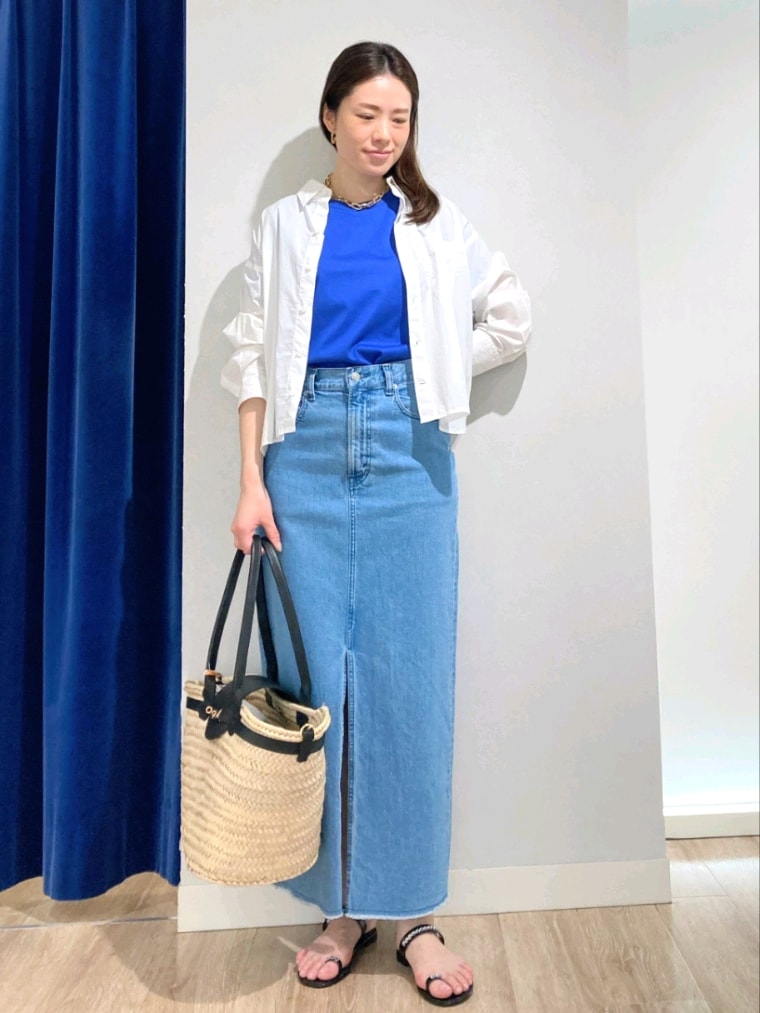 ブルー系のTシャツ/カットソー、ホワイト系のシャツ/ブラウス、ブルー系のデニムスカートを着用したレディースの夏コーディネートの2枚目の写真