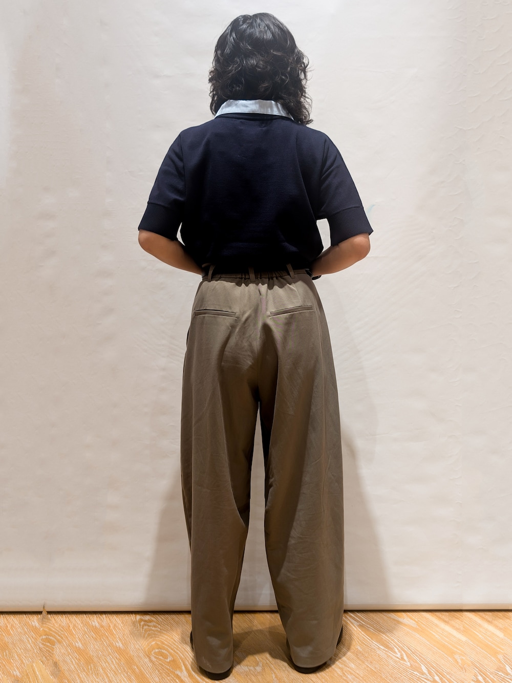 ブルー系のニット/セーター、グリーン系のその他パンツ、ブラック系のトートバッグを着用したレディースの夏コーディネートの3枚目の写真