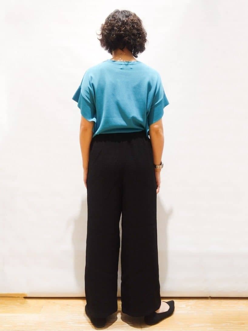 ブルー系のニット/セーター、ブラック系のその他パンツ、ブラック系のパンプスを着用したレディースの春コーディネートの2枚目の写真