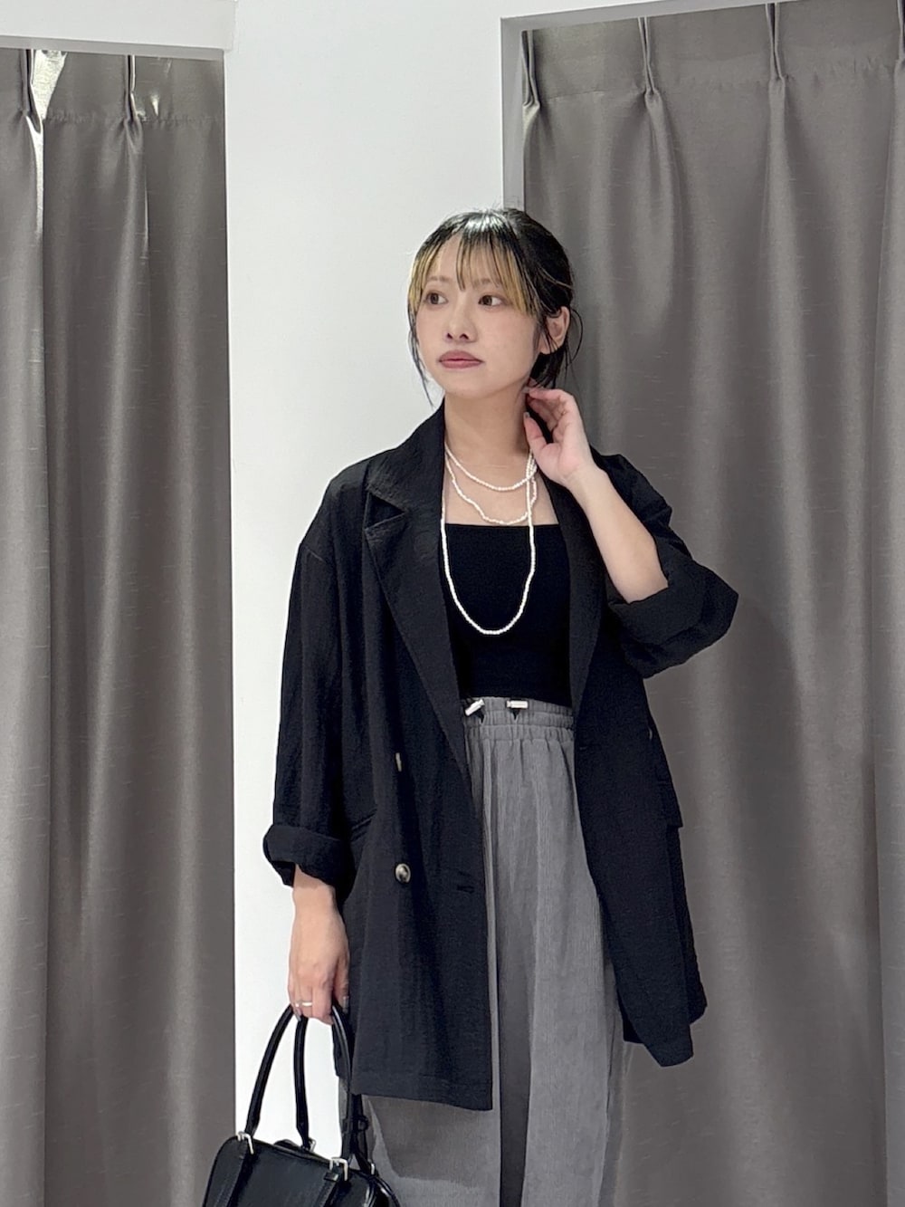 ブラック系のパンプス、ブラック系のショルダーバッグ、グレー系のその他パンツを着用したレディースの夏コーディネートの5枚目の写真